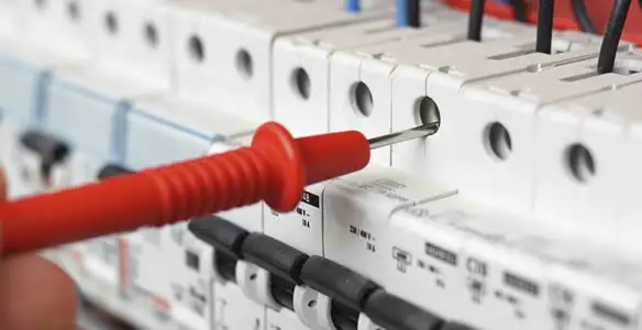 Electrical contractor testing circuit breakers during electrical repair in New Palestine, IN