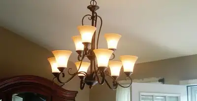 Classic ceiling chandelier installation with warm lighting in Indianapolis, IN