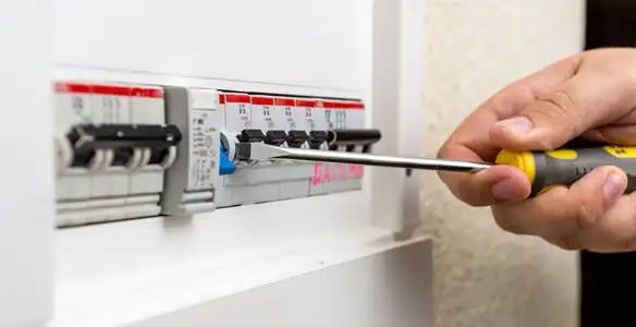 electrical panel upgrade service showing technician adjusting circuit breakers during system upgrade in Indianapolis, IN