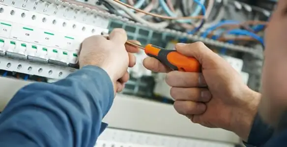 electrical service showing licensed electrician performing electrical panel maintenance and adjustments in Indianapolis, IN