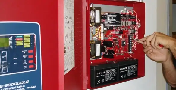 fire alarm installation service showing technician configuring fire alarm control panel in Indianapolis, IN