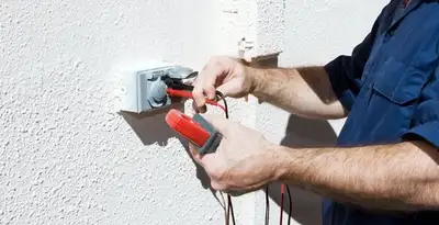Electrician performing home electrical outlet and wiring inspection in Indianapolis, IN