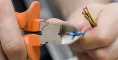 professional electrical services showing precise wire cutting by licensed electricians in Indianapolis, IN