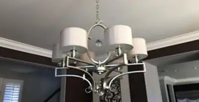 Modern chandelier installation with multiple light fixtures in Indianapolis, IN