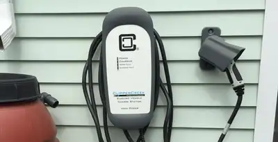Outdoor electric vehicle charger installation on residential wall in Indianapolis, IN
