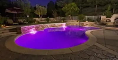 pool light installation and repair services illuminating a residential swimming pool in Indianapolis, IN